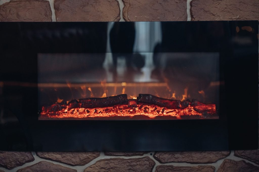 Close-up of logs burning in a stone fireplace