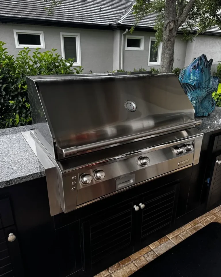 New Alfresco built-in grill in a dark outdoor kitchen island