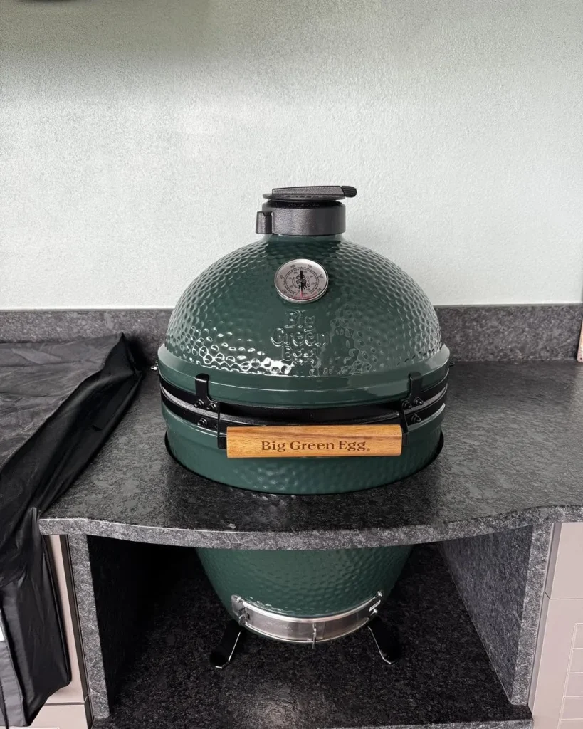 Big Green Egg kamado grill set into a granite outdoor counter