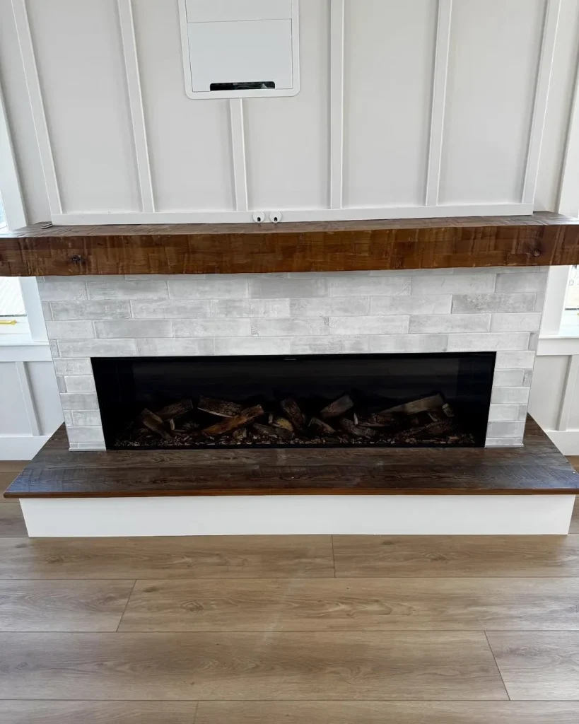 British Fires linear electric fireplace with wood mantel in a new home