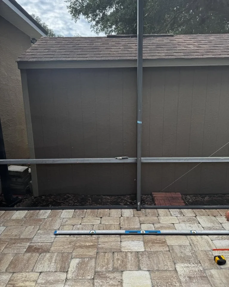 Before and after of an L-shaped stone outdoor kitchen on a paver patio