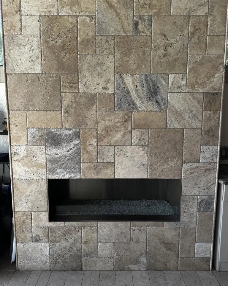 Outdoor travertine fireplace wall before and after an outdoor-rated electric insert