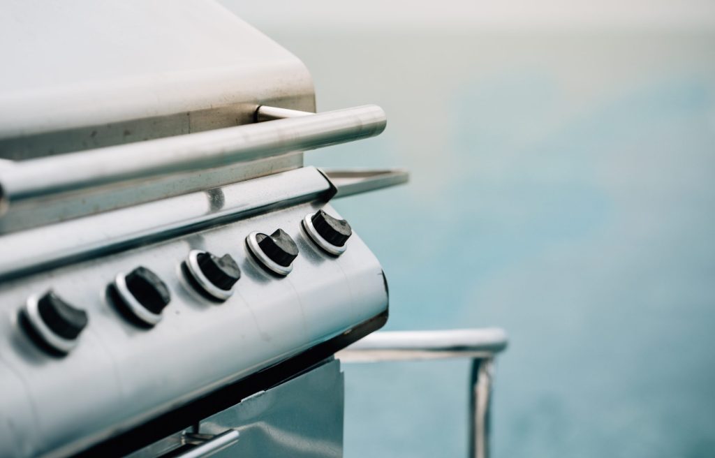 Close-up of a stainless gas grill control knob