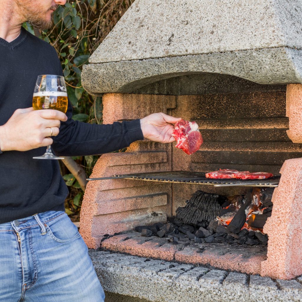 Grilling steak on a backyard barbecue