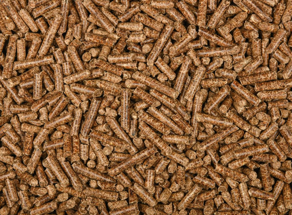 Close-up of dry, intact hardwood smoking pellets used to fuel a pellet grill
